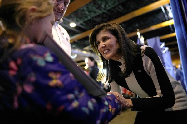 Republican presidential candidate former UN Ambassador Nikki Haley greets an audience member during a campaign event at Jethro's BBQ in Ames, Iowa, Sunday, Jan. 14, 2024. (AP Photo/Carolyn Kaster)